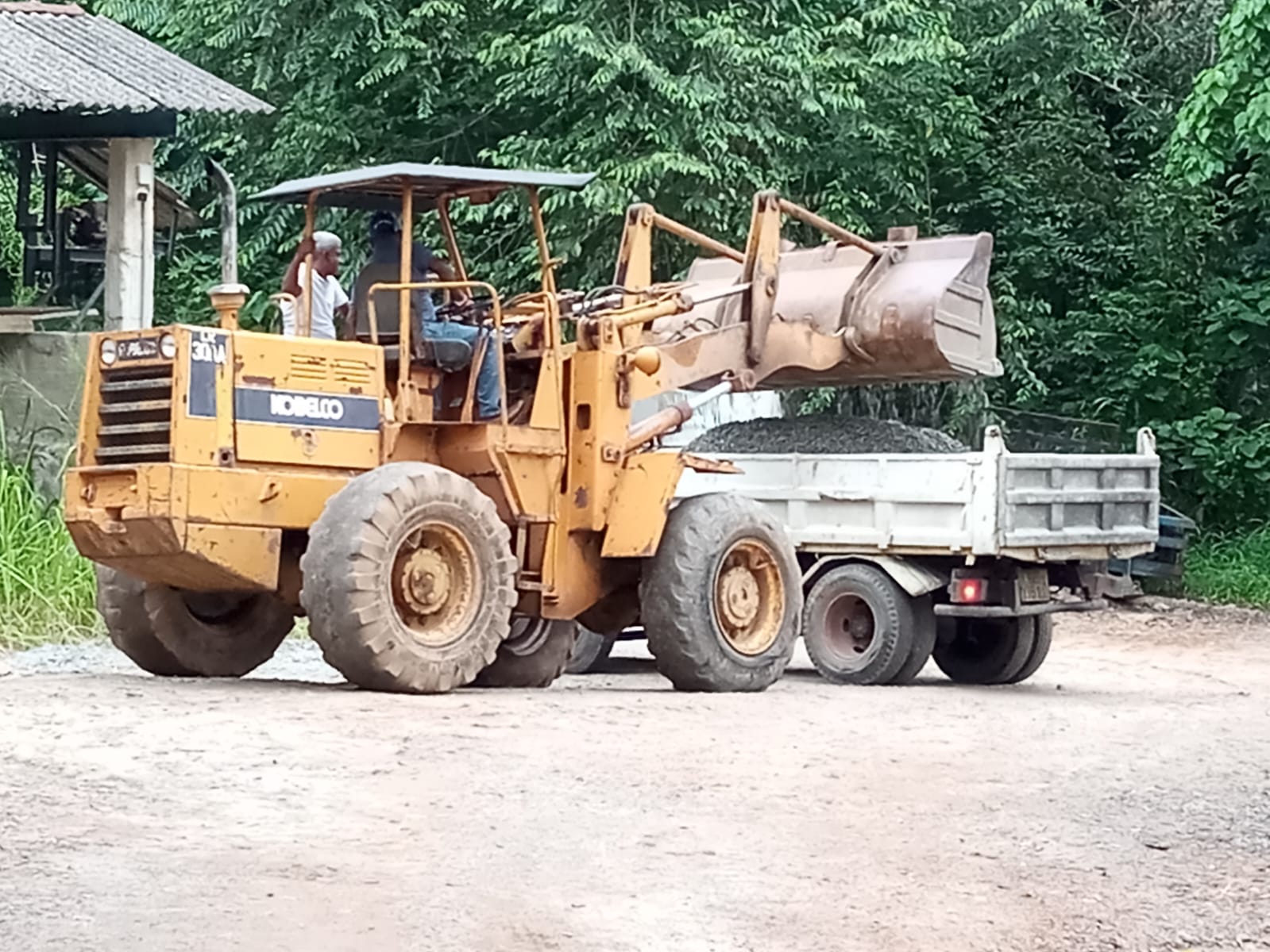 Wheel loader loading crushed aggregate onto a delivery truck